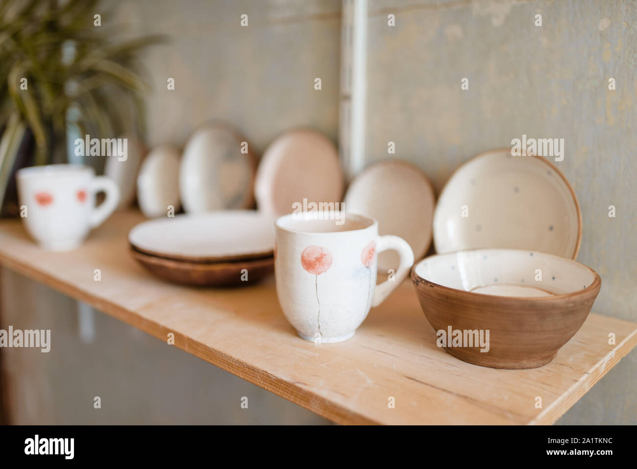 Kitchen utensils on shelf in pottery workshop Stock Photo