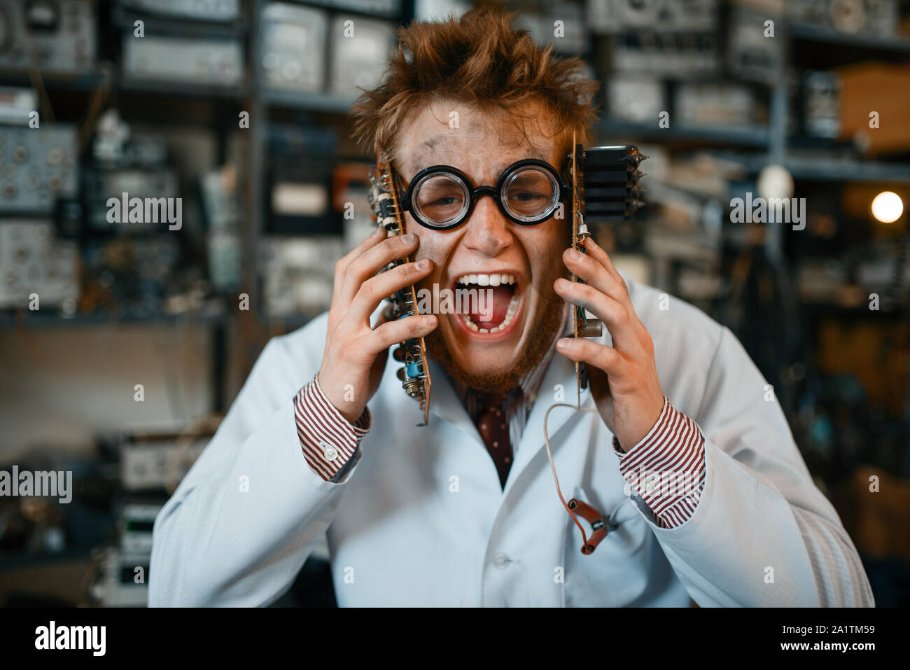 Strange engineer holds chips at his face in lab Stock Photo - Alamy