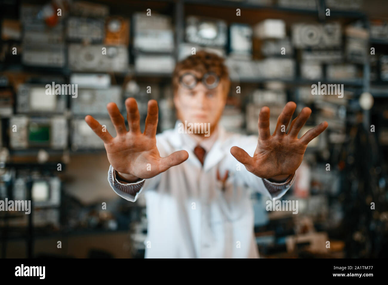 Strange scientist showing scorched hands in lab Stock Photo