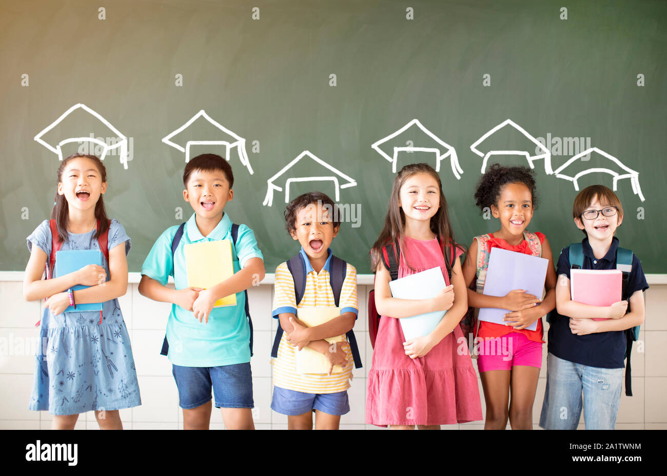 Group of diverse young students standing together in classroom Stock ...