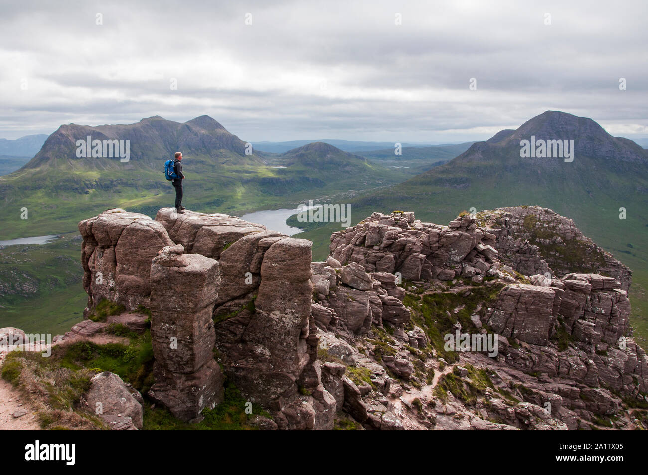 Hill walker on the summit of Stac Pollaidh, Assynt, NW Scotland Stock Photo