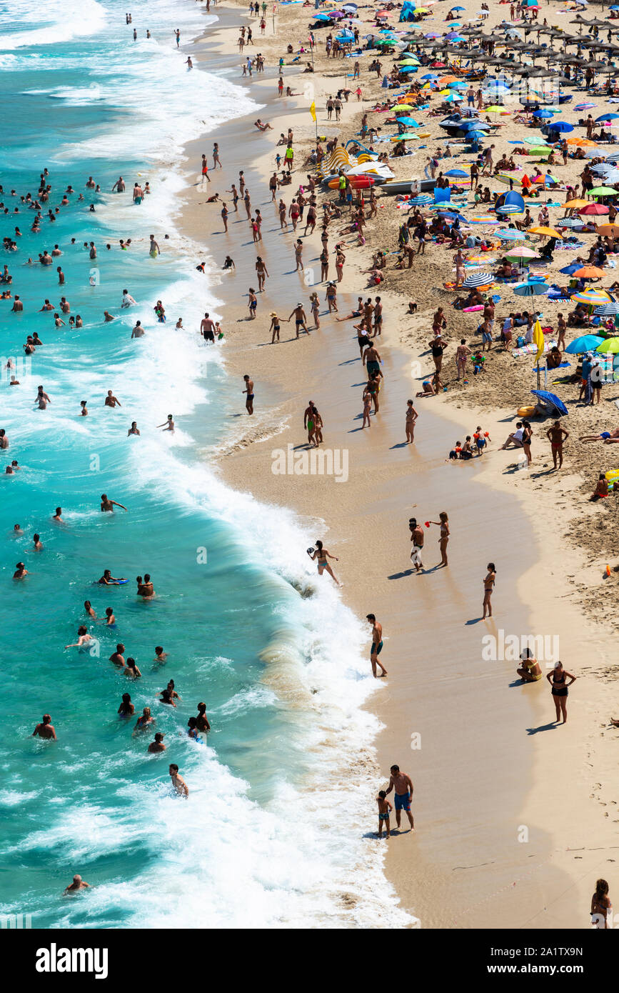 Mallorca, Spain, August 16, 2019: view from the top, of the beach and shoreline crowded with tourists and umbrellas Stock Photo
