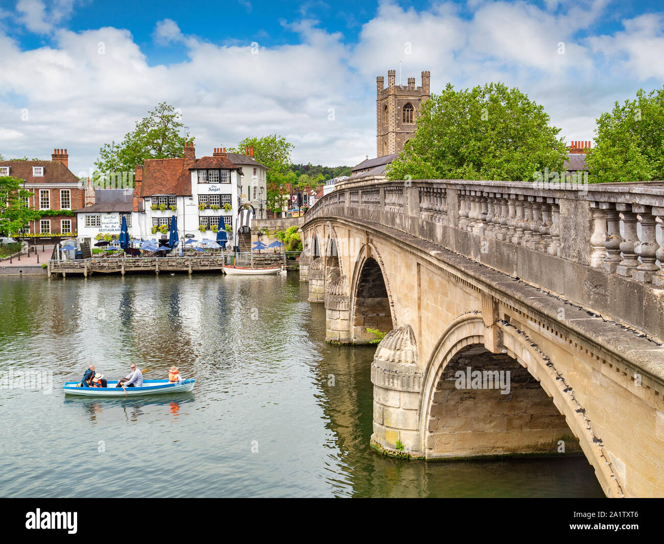 4 June 2019: Henley on Thames, UK - Henley Bridge and the River Thames, with The Angel riverside pub and restaurant, and family in rowing boat on rive Stock Photo