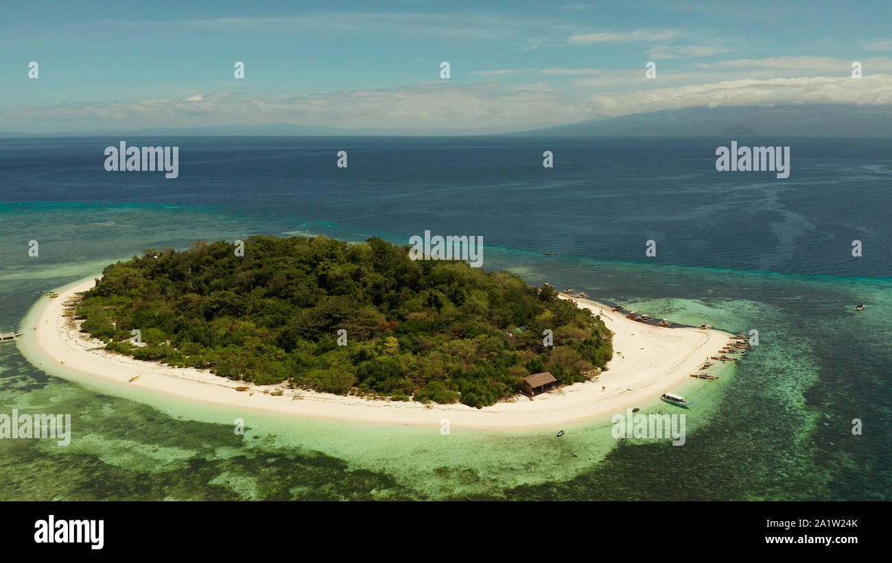 Tropical island with sandy beach with atoll and coral reef, aerial ...