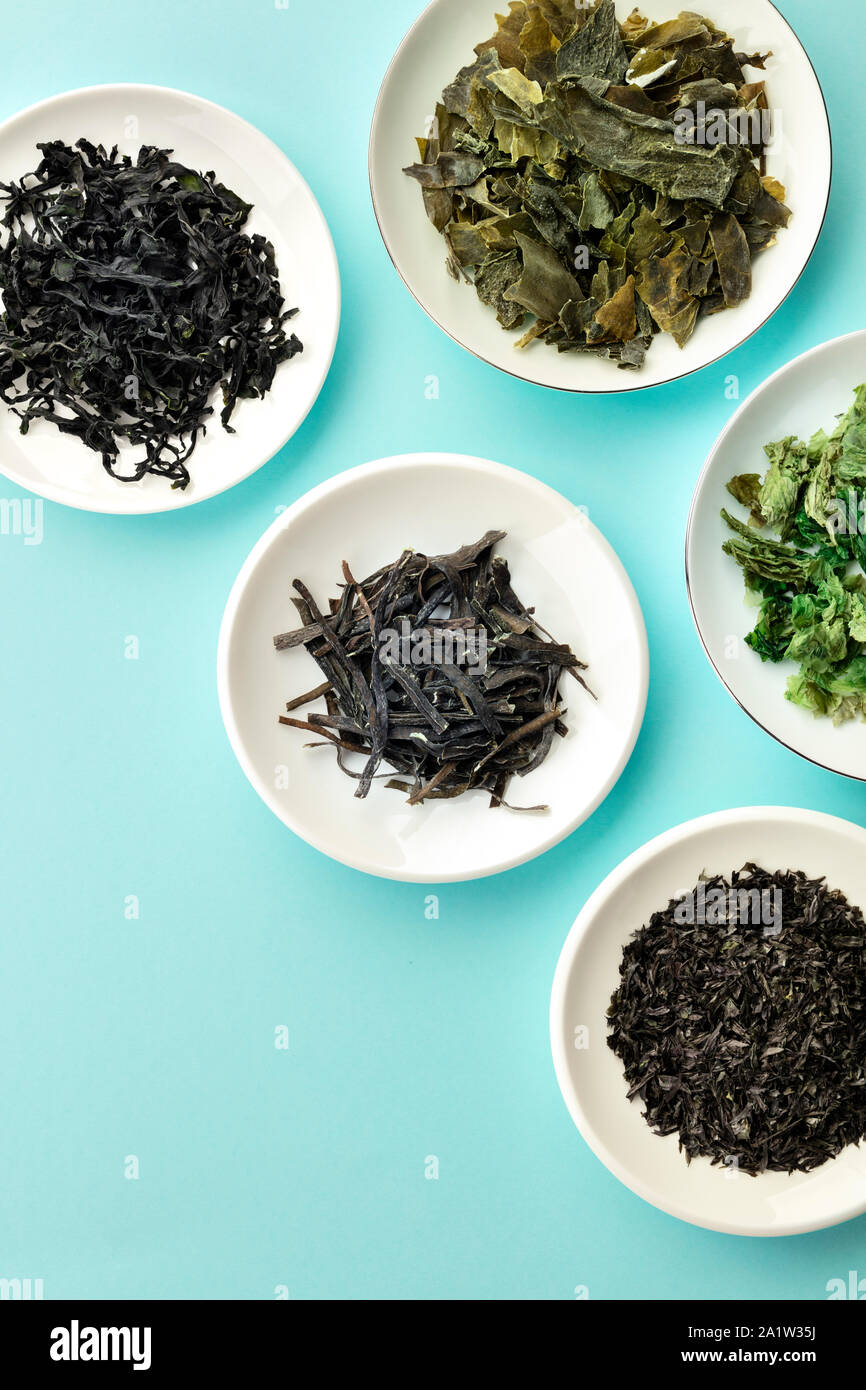 Dry seaweed, sea vegetables, shot from above on a teal blue background with copy space Stock Photo
