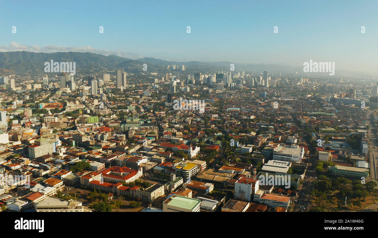 Aerial view of panorama of the city of Cebu with skyscrapers and buildings during sunrise. Philippines. Stock Photo