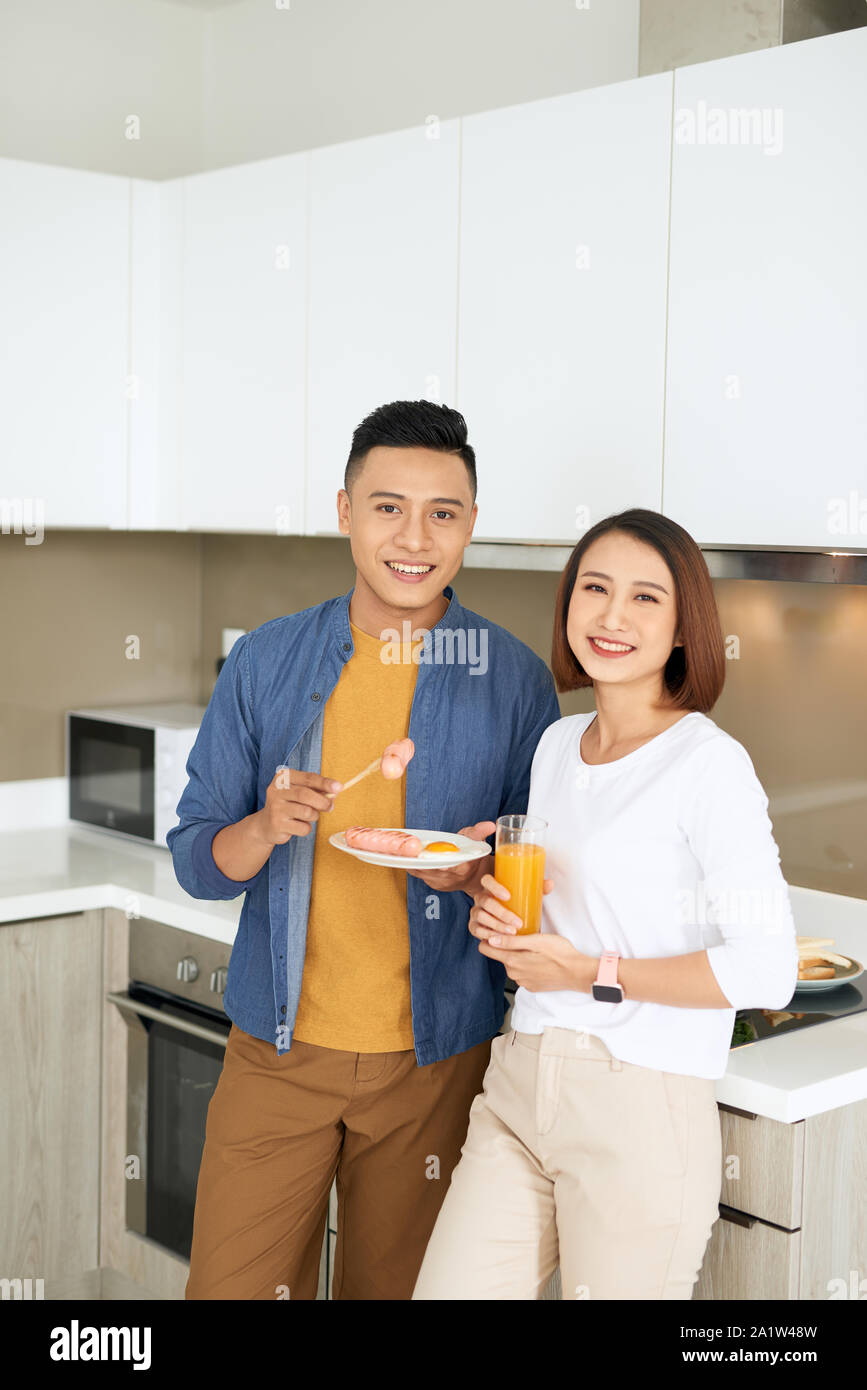 Couple cooking together in the kitchen at home Stock Photo