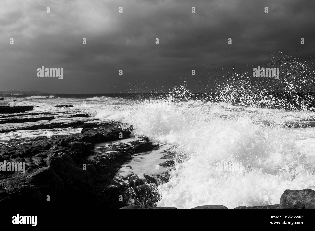 Waves sea crashing rocks formation Black and White Stock Photos ...