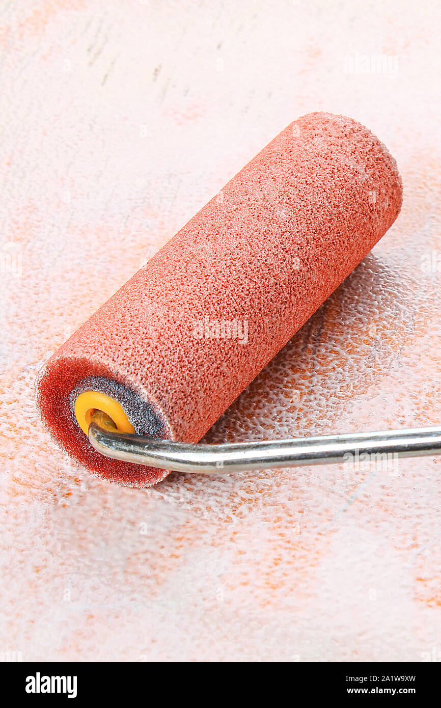 paint roll brush in white paint on plywood surface Stock Photo Alamy