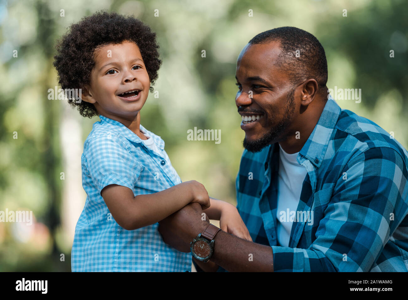 happy african american father holding hands with cute son Stock Photo ...