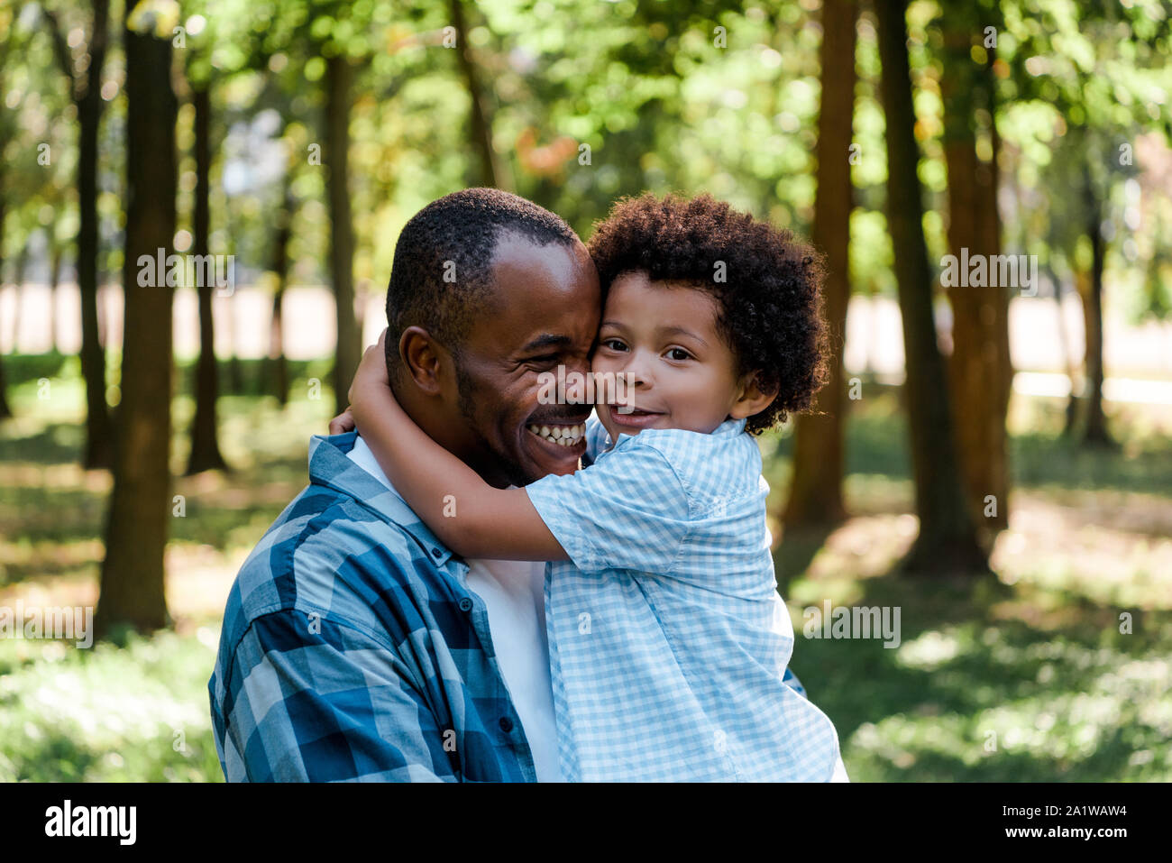 cute african american kid hugging happy father Stock Photo - Alamy
