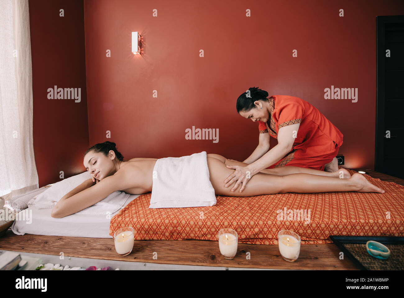 side view of asian masseur doing foot massage to woman in spa salon Stock  Photo - Alamy