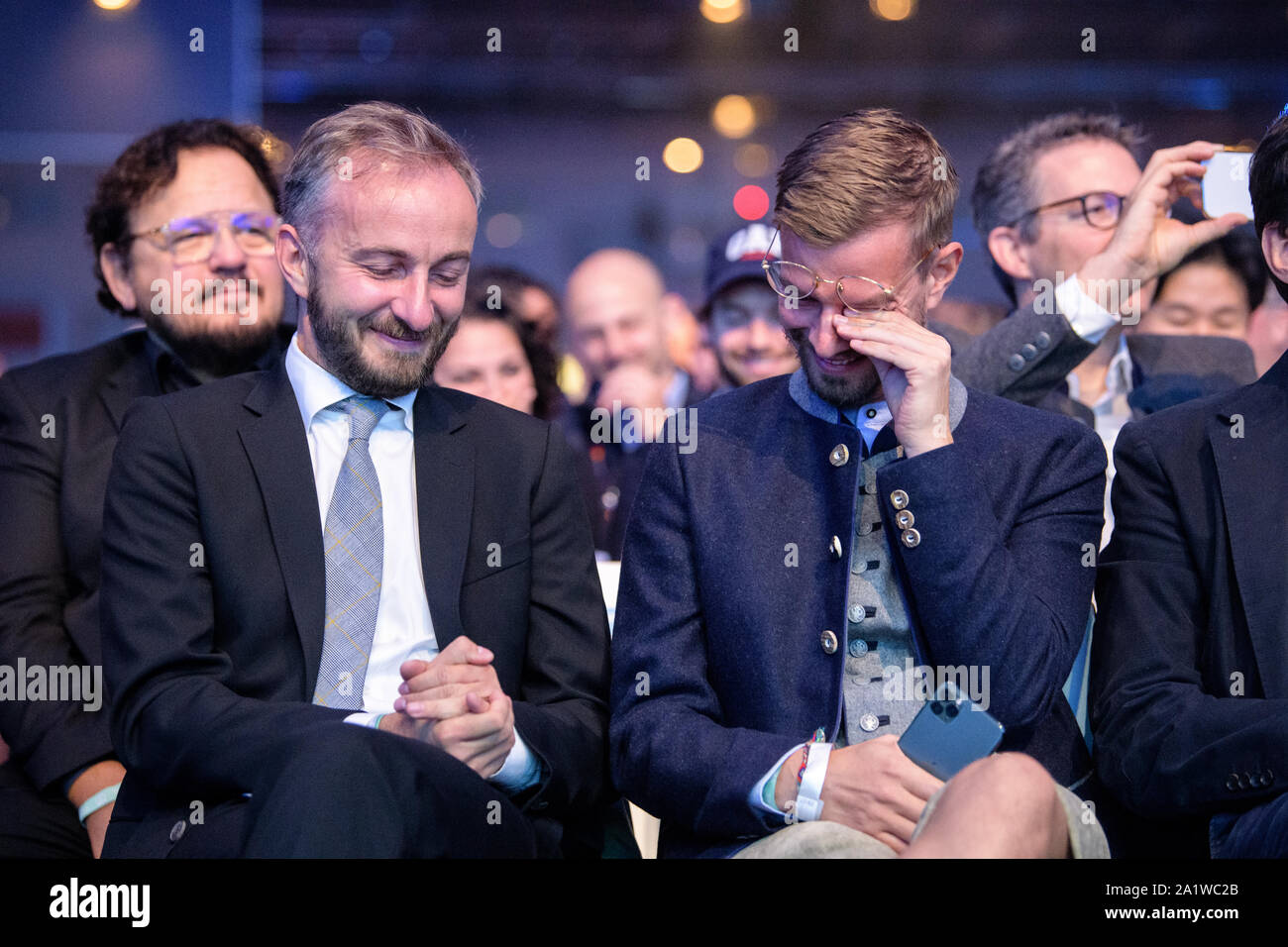 Munich, Germany. 29th Sep, 2019. Jan Böhmermann (l), TV entertainer, and  Joko Winterscheidt, TV presenter, smile during the opening speech of the  company's founder and investor meeting Bits & Pretzels. At Bits