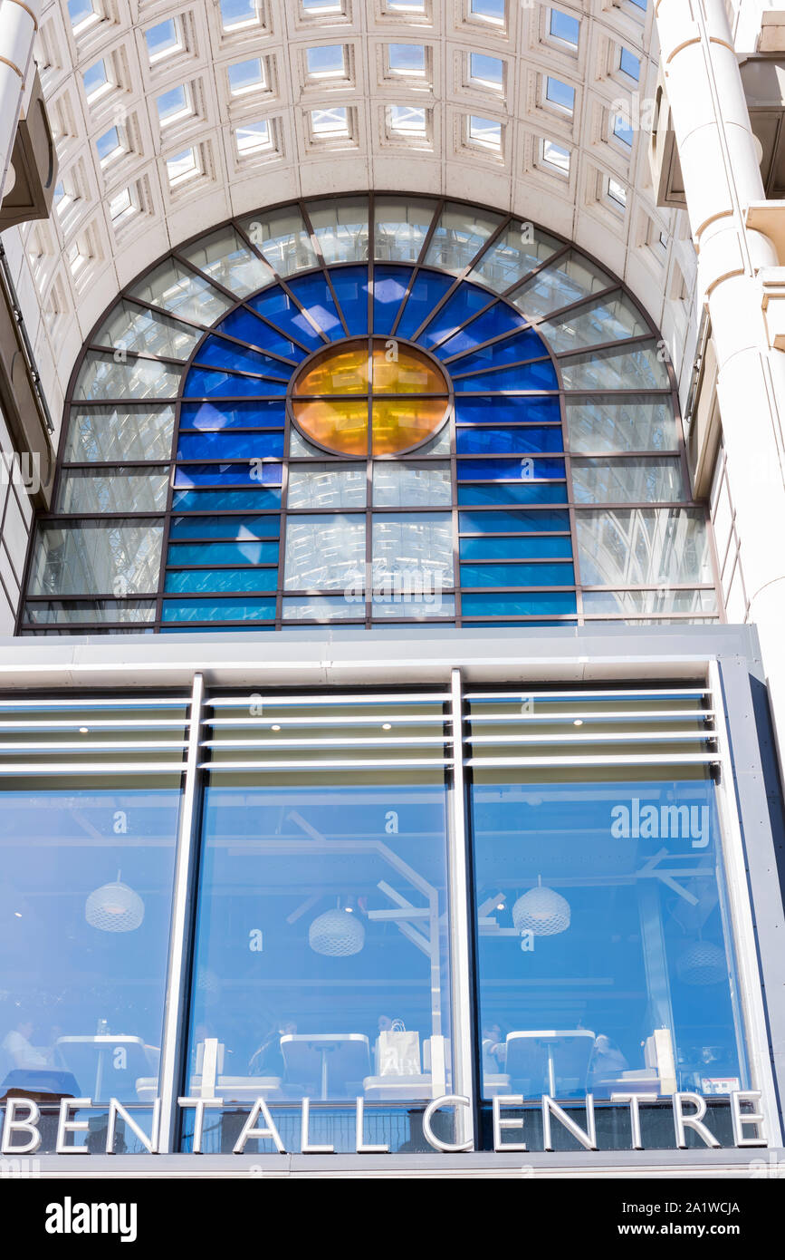 Modern glass arch and stained glass coloured windows at entrance of