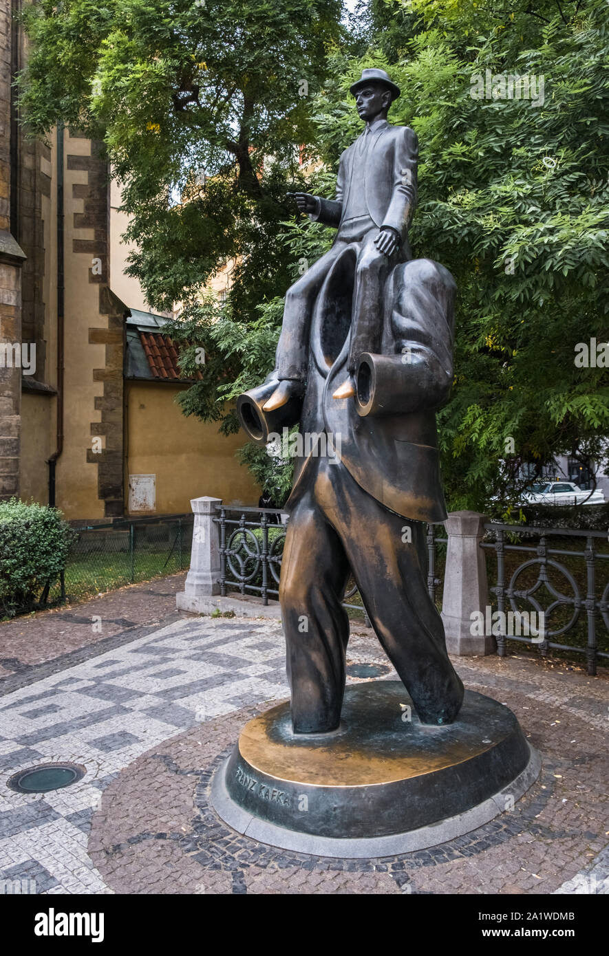 Memorial statue to Czech author Franz Kafka, depicted as riding on  shoulders of a headless figure, Vězeňská Street, Jewish Quarter, Prague, Czechia. Stock Photo