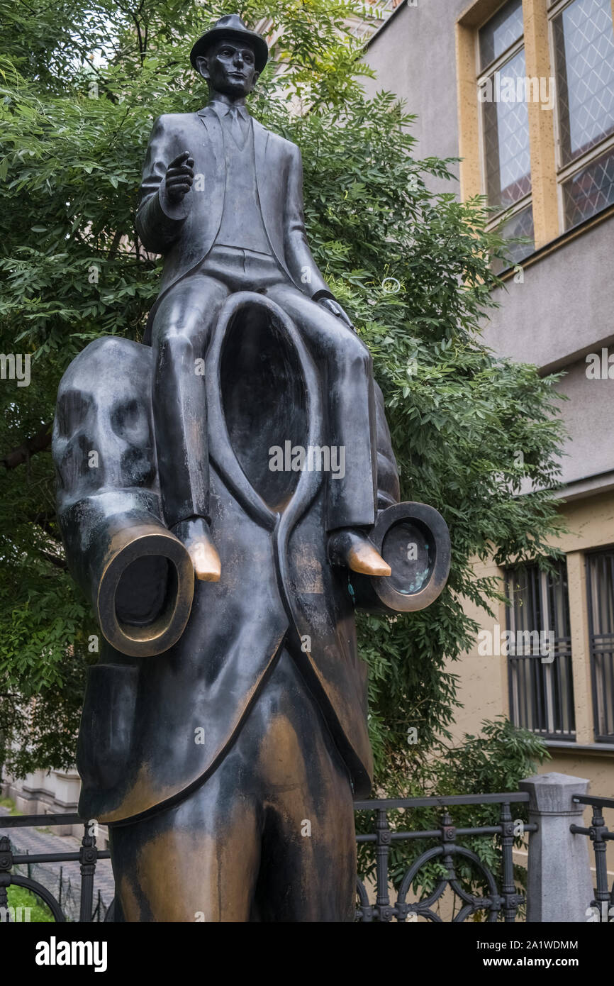 Memorial statue to Czech author Franz Kafka, depicted as riding on  shoulders of a headless figure, Vězeňská Street, Jewish Quarter, Prague, Czechia. Stock Photo