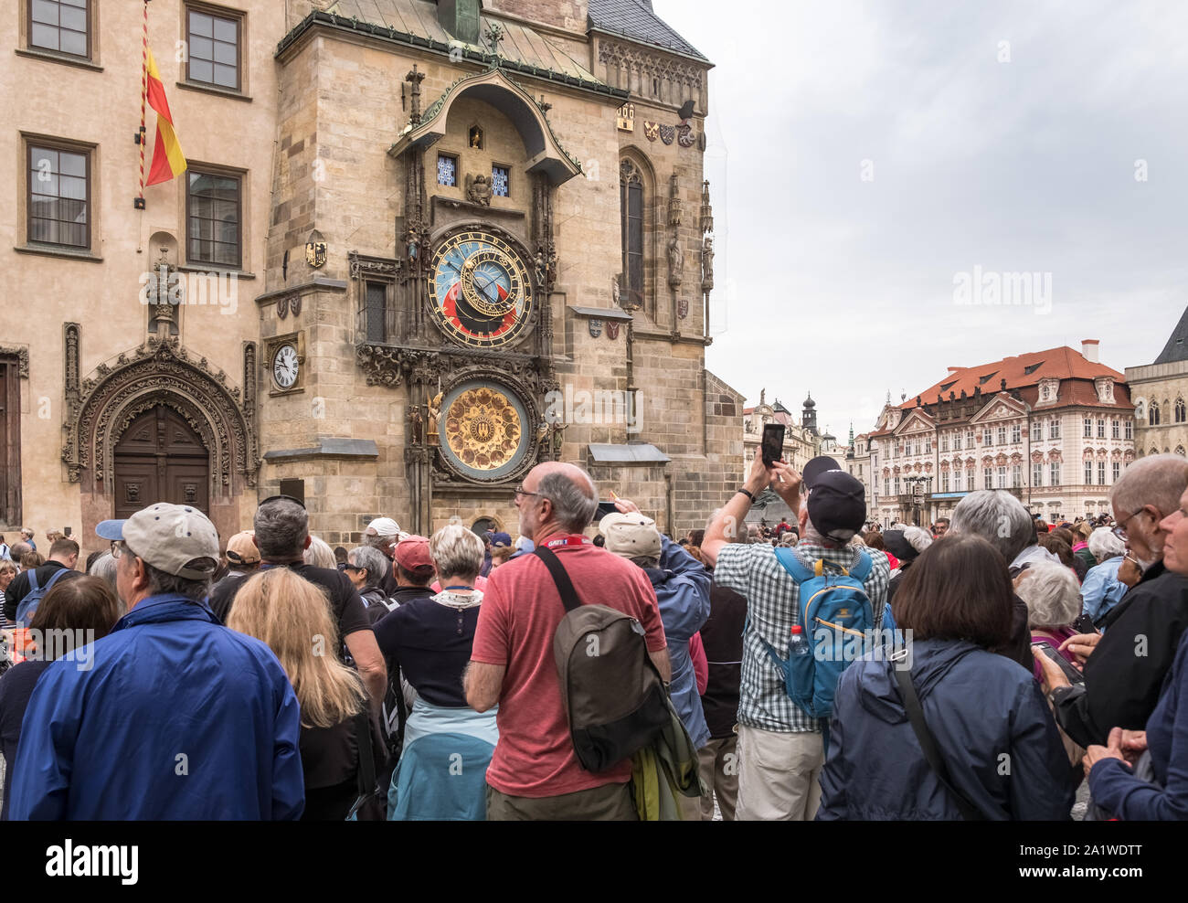 Tourists crowd gather at the medieval Astronomical Clock, a popular tourist attraction in Old Town Square, Prague, Czech Republic. Stock Photo