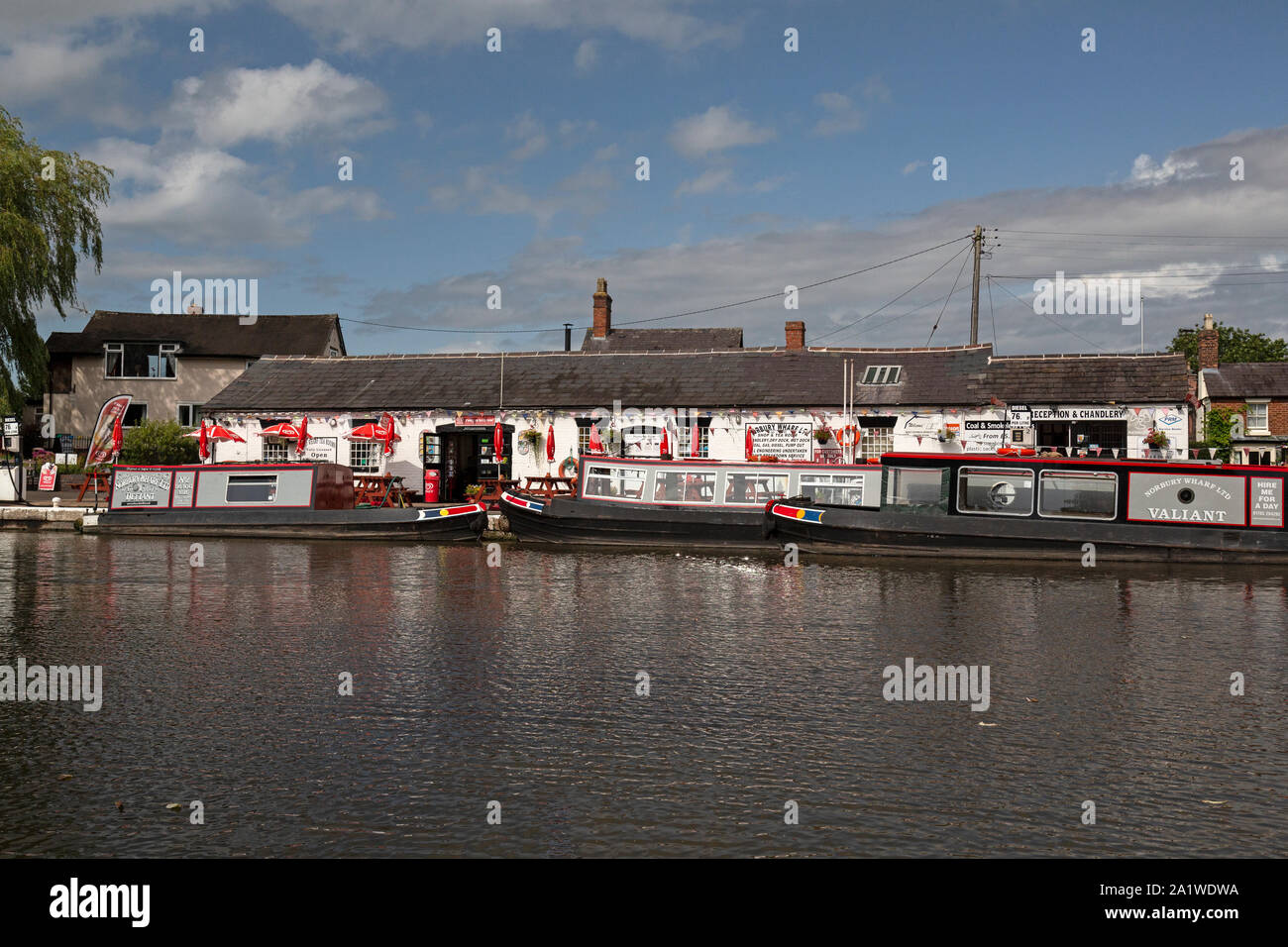 Narrow Boats, or Barges, moored up at Norbury Wharf on The Shropshire Union Canal in England. Stock Photo