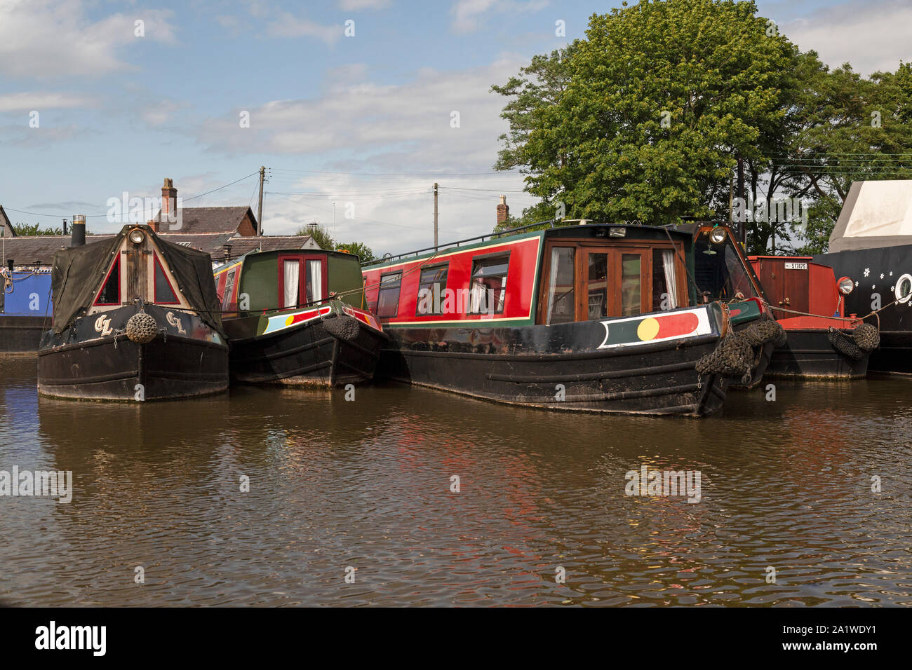 Narrow Boats, or Barges, moored up at Norbury Wharf on The Shropshire Union Canal in England. Stock Photo