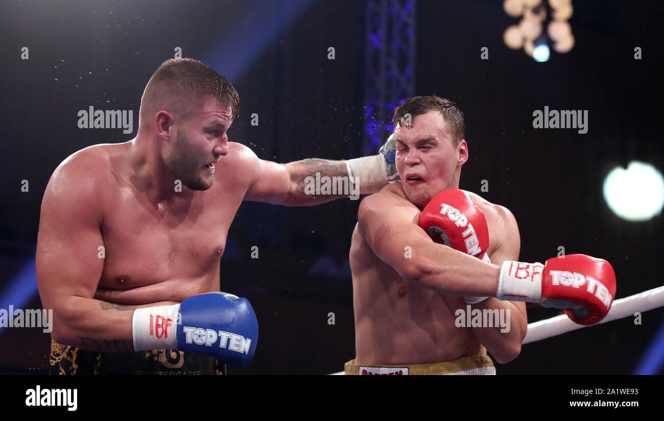 Magdeburg, Germany. 28th Sep, 2019. Boxing: IBF-International title in the  heavyweight black - Ilja in the Stadthalle. Tom Schwarz (l) from Magdeburg  is boxing against Ilja Mezencev (r) from Hamburg. Schwarz won