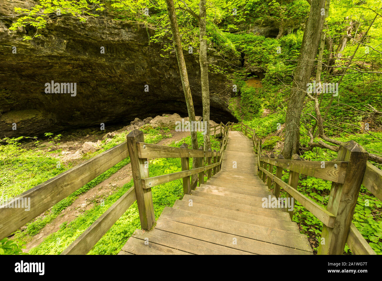 A cave with steps leading down to the entrance. Stock Photo
