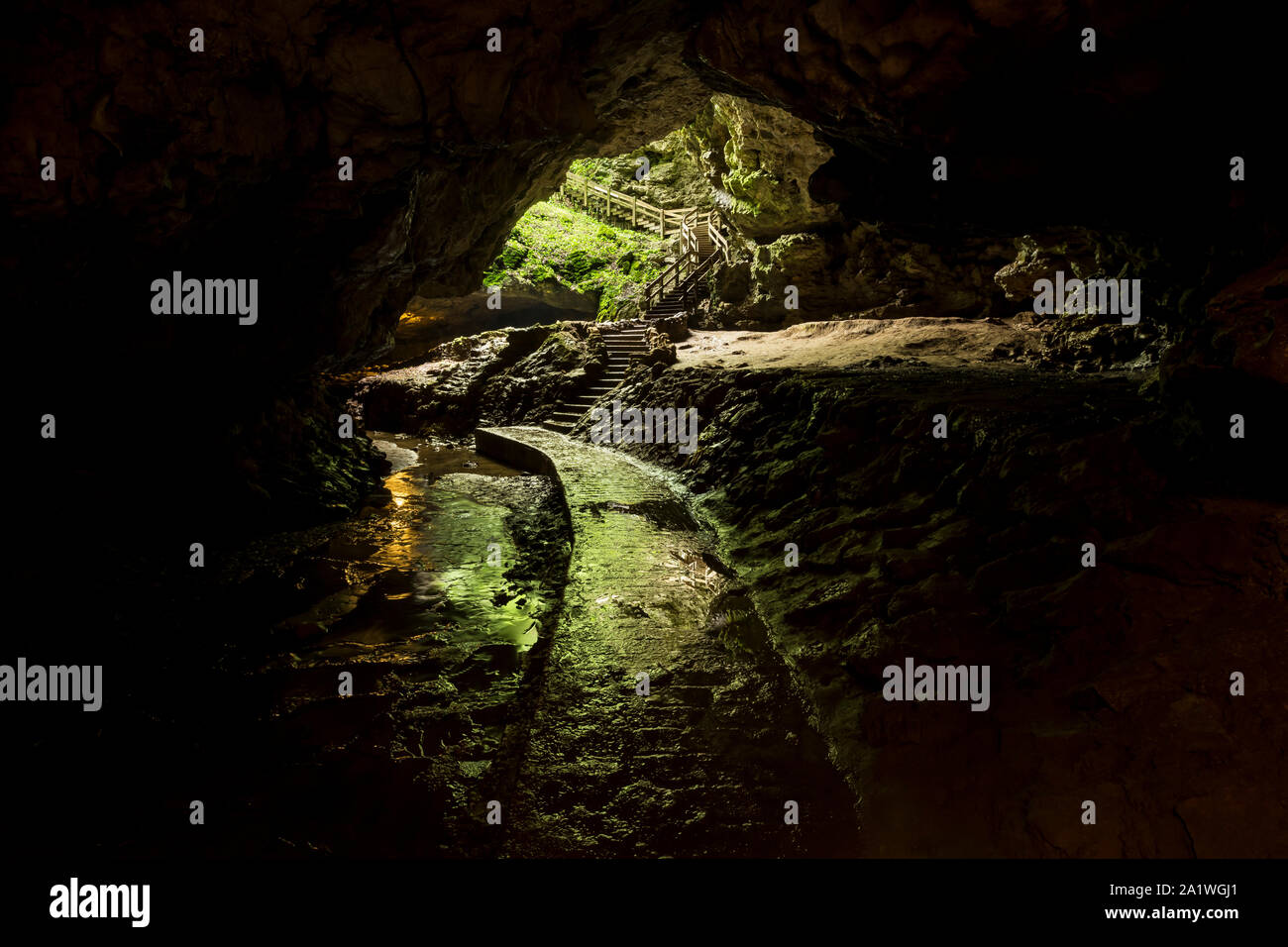 A Path Inside A Cave Leading To The Entrance Stock Photo