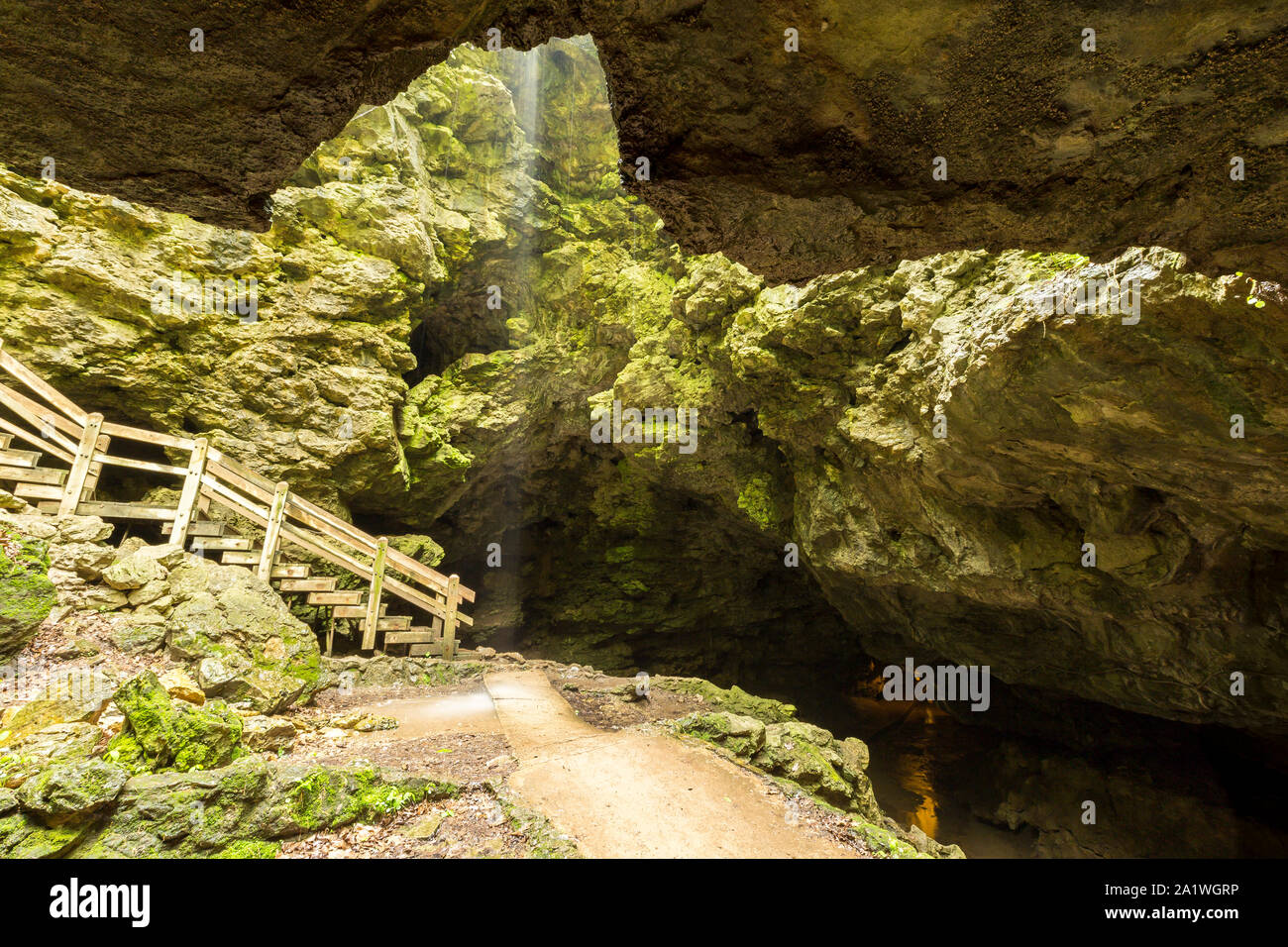 Inside A Cave Looking At The Entrance With Waterfall Stock Photo