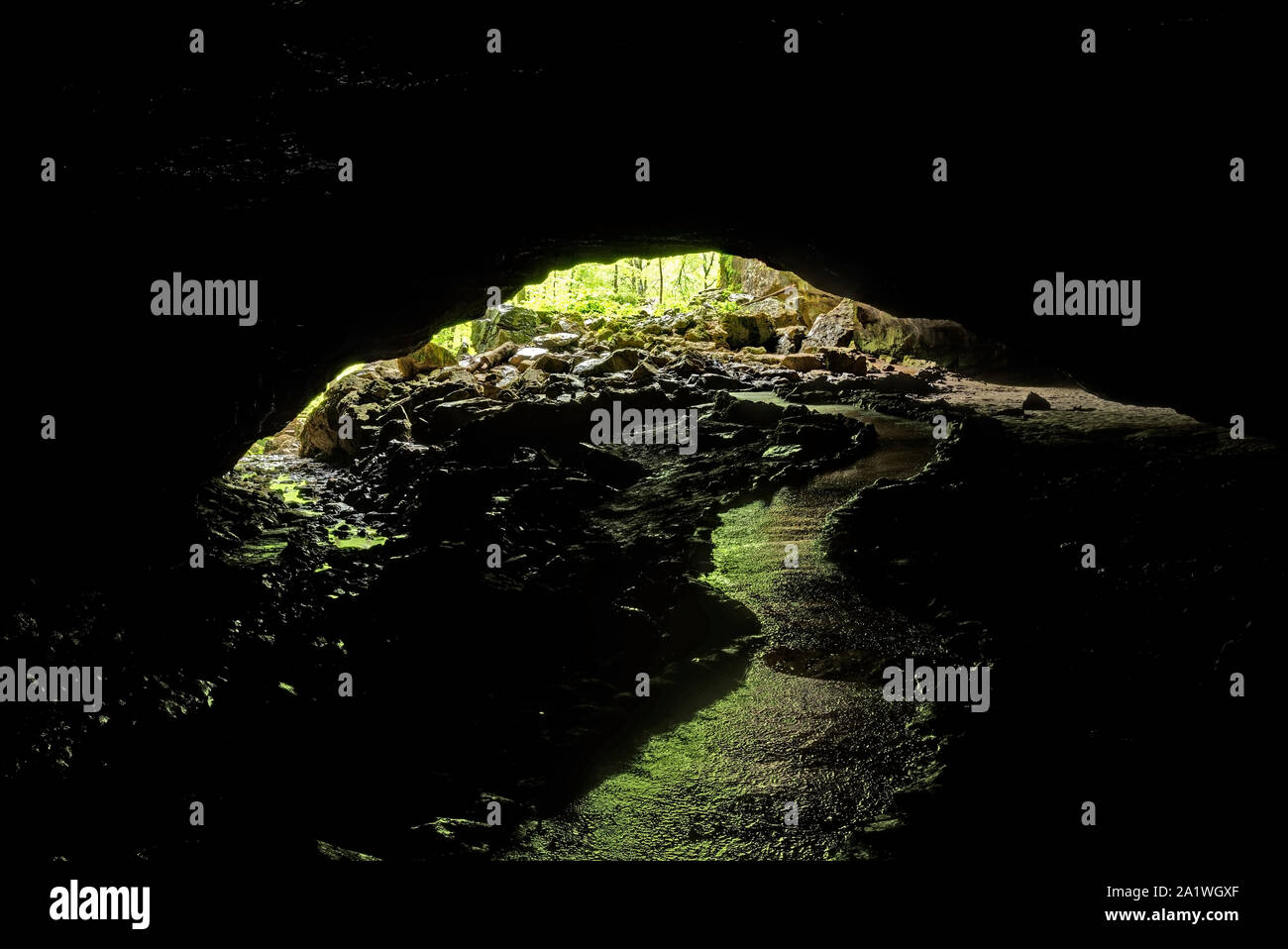 A Path Inside A Cave Leading To The Entrance Stock Photo