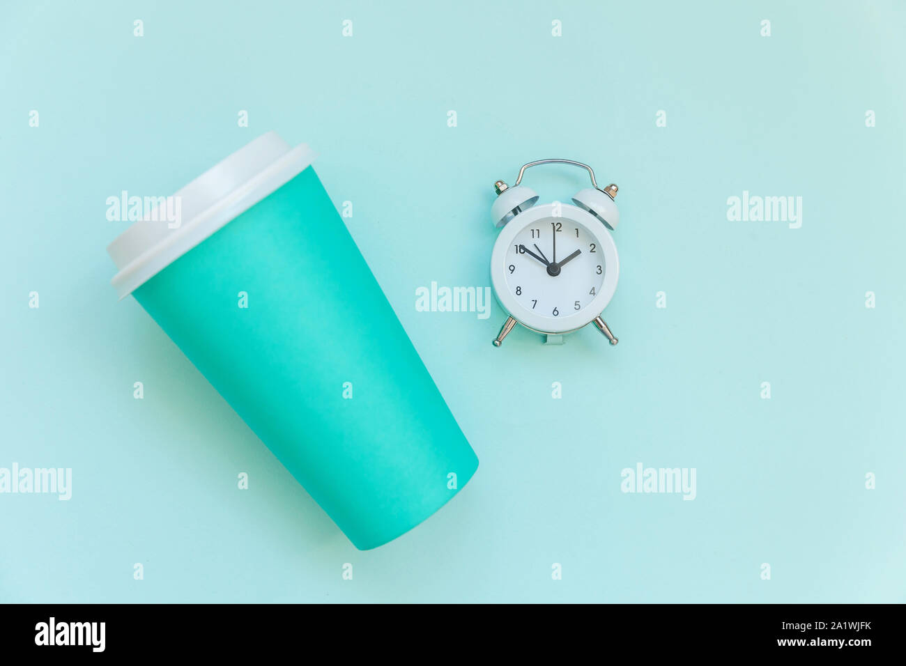 Simply flat lay design blue paper coffee cup and alarm clock isolated ...