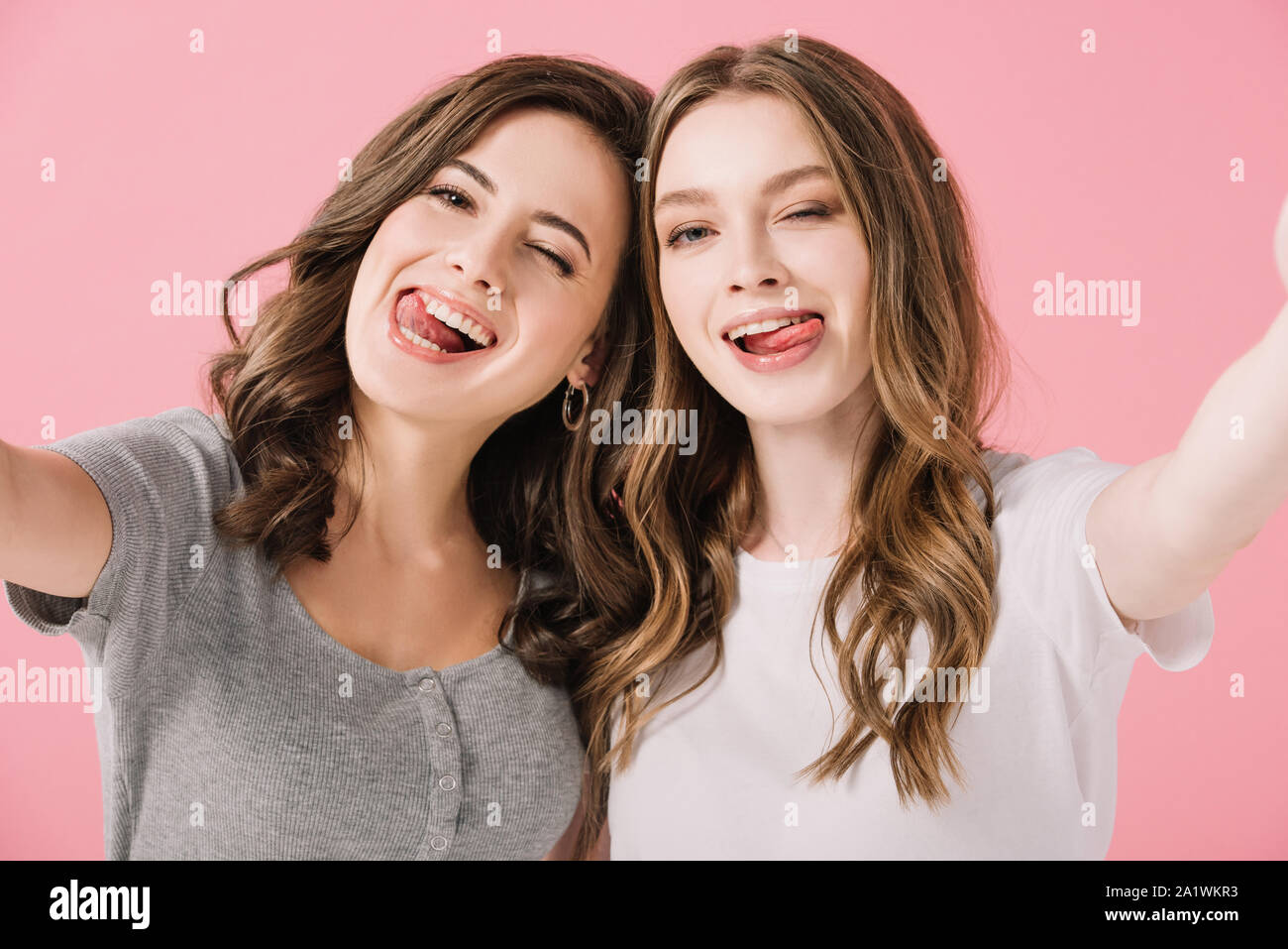 Two girls sticking out tongues hi-res stock photography and images - Alamy