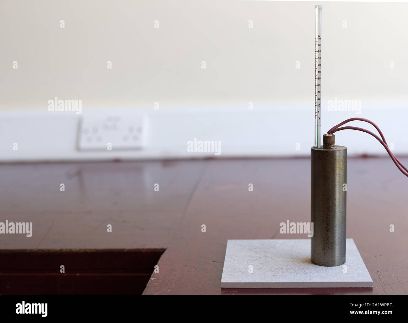 Specific Heat Capacity of Steel Experiment Set up with no insulation. Steel  block with an immersion heater and thermometer on a heatproof mat Stock  Photo - Alamy