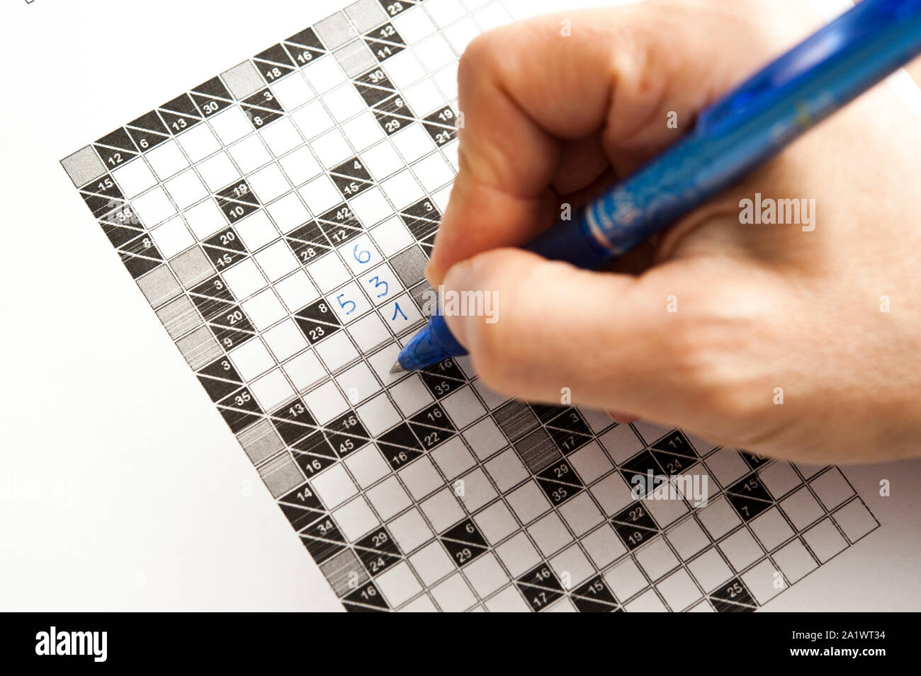 hand filling a kakuro math puzzle Stock Photo Alamy