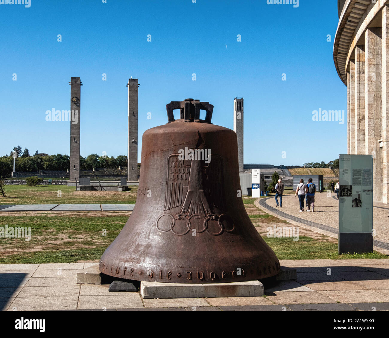 Berlin, Olympic Stadium grounds. Tall Towers & damaged Olympic Bell from the Bell Tower is inscribed with Olympic Rings, an eagle, the year 1936 Stock Photo