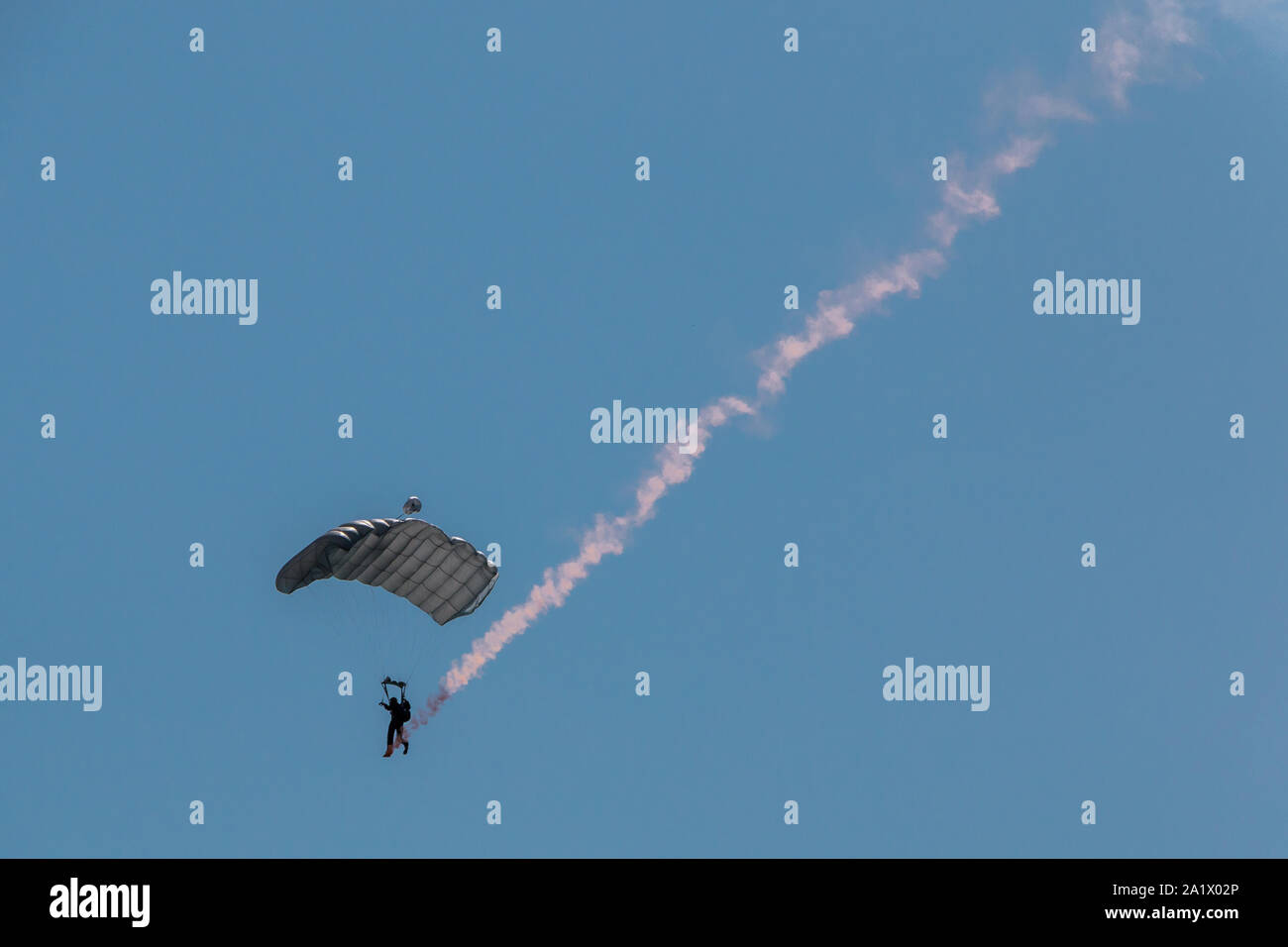 German skydiver in the air with a tail of smoke Stock Photo