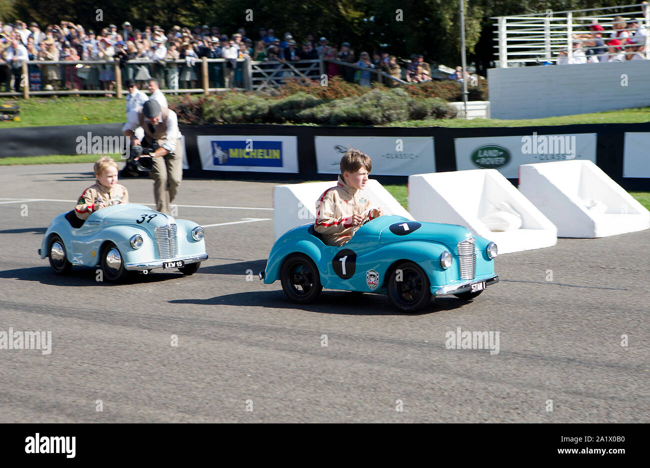 Children in their vintage Austin J40 pedal cars as entered in The Settrington Cup race at The Goodwood Revival 14th Sept 2019 in Chichester, England. Stock Photo