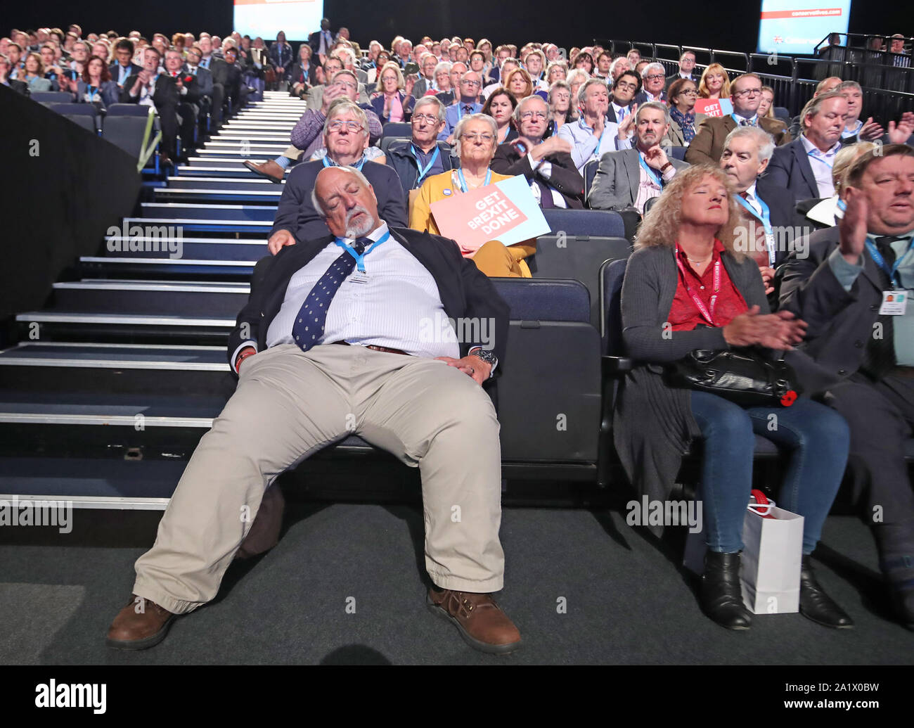 People listen to speakers at the Conservative Party Conference being