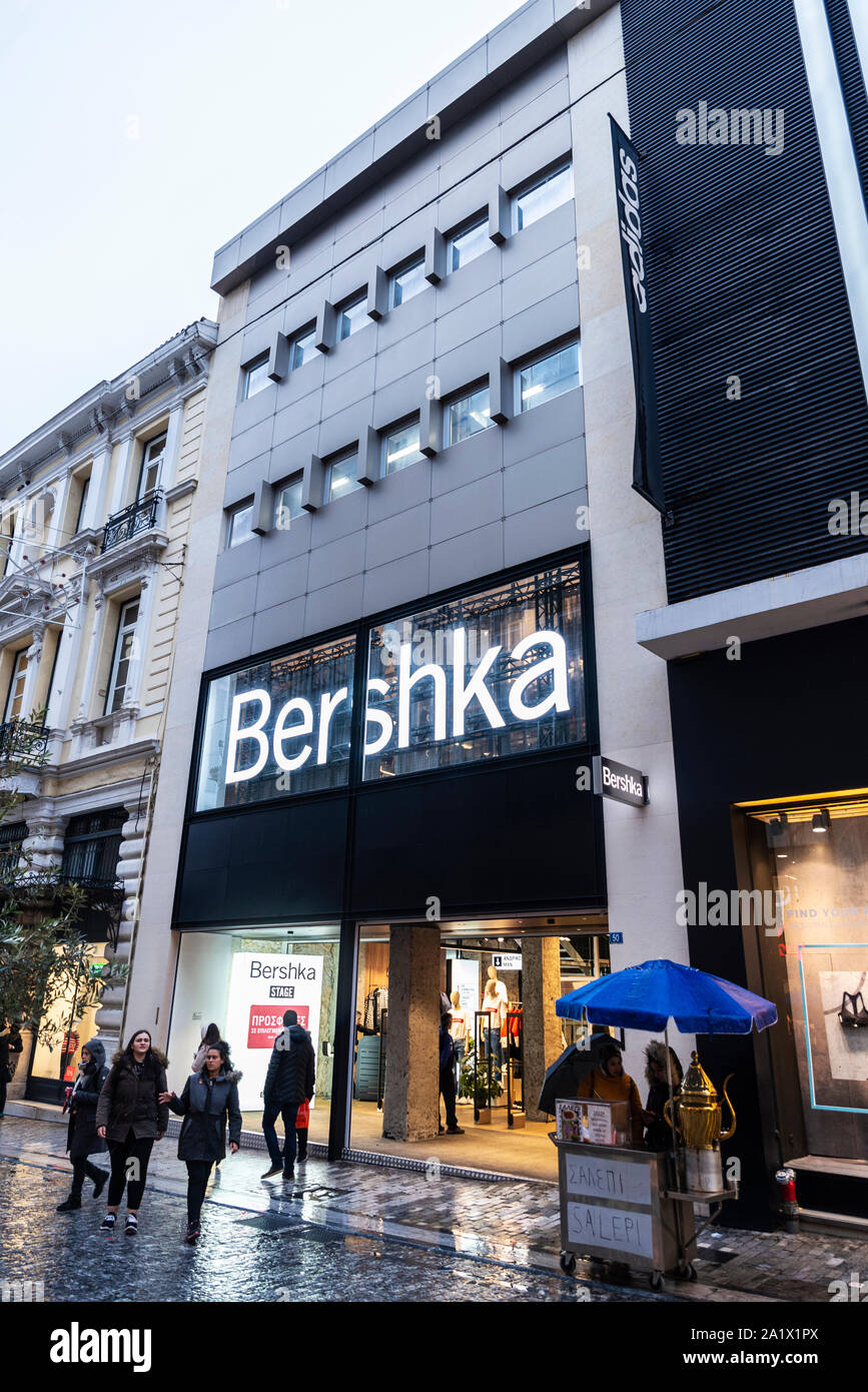 Athens, Greece - January 4, 2019: Display of a Bershka store at night with people around in Athens, Greece Stock Photo