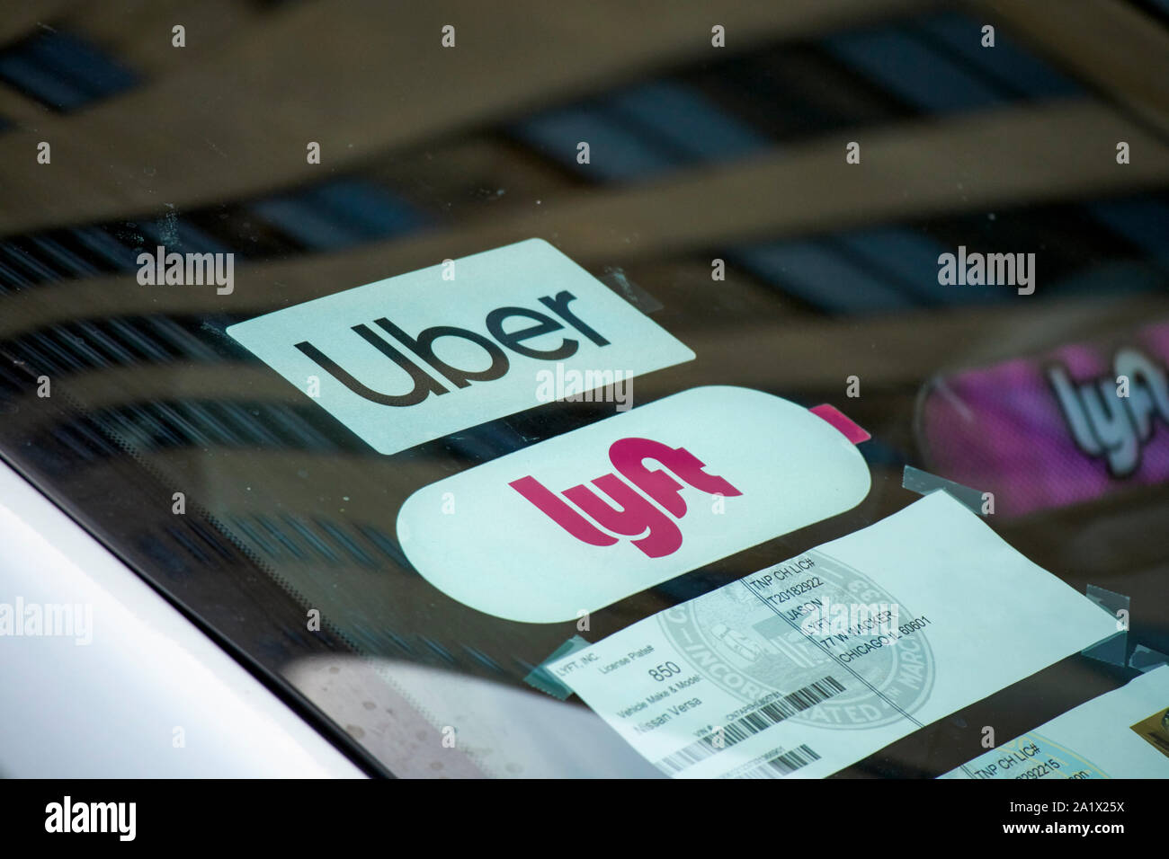stickers in the windshield of a cab for both uber and lyft chicago illinois united states of america Stock Photo