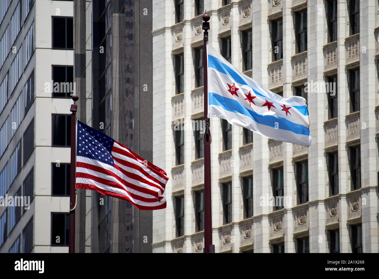 us and chicago city flags flying in downtown chicago in the windy city