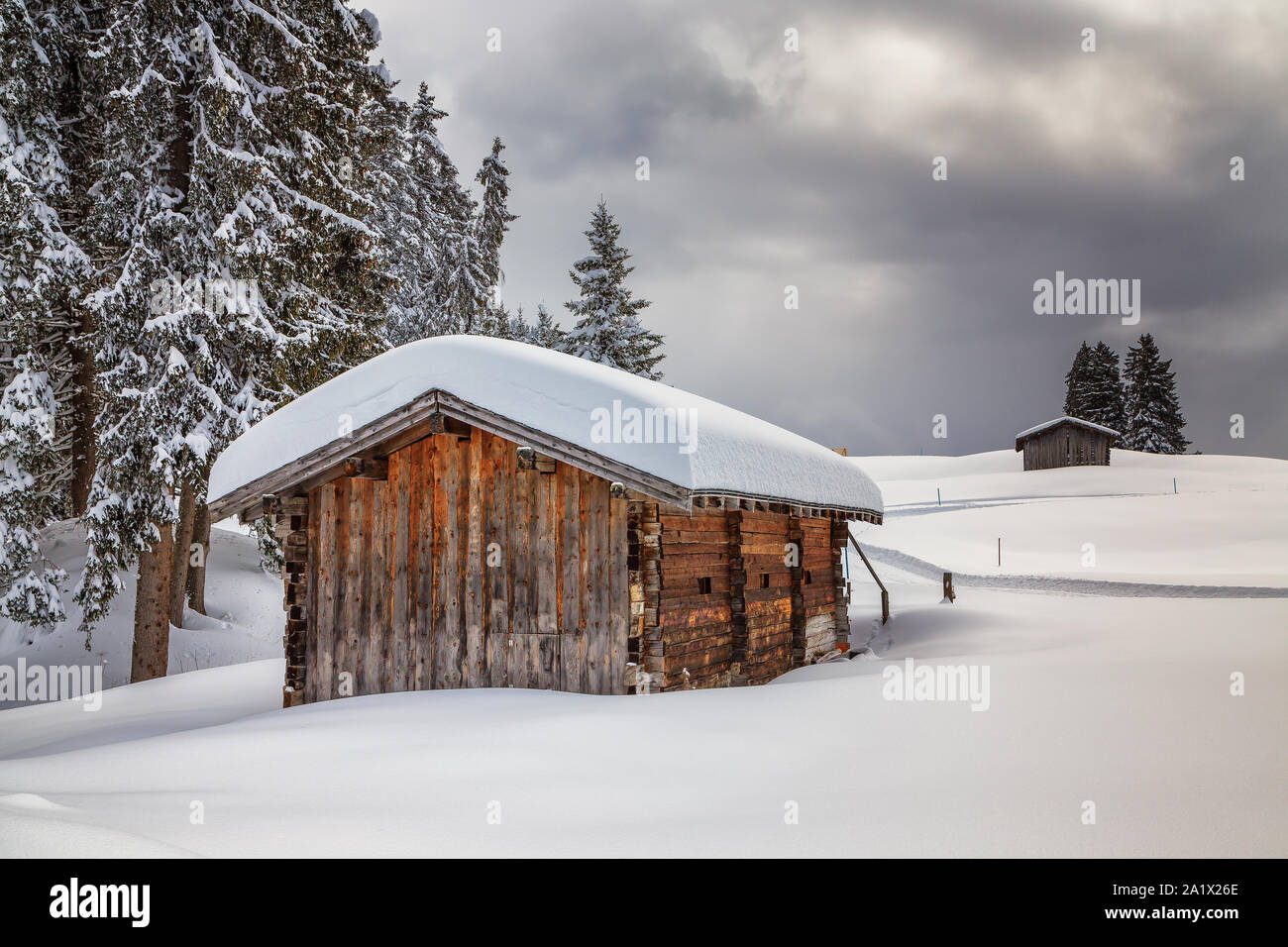 wooden hut in snowy landscape of grisons Stock Photo
