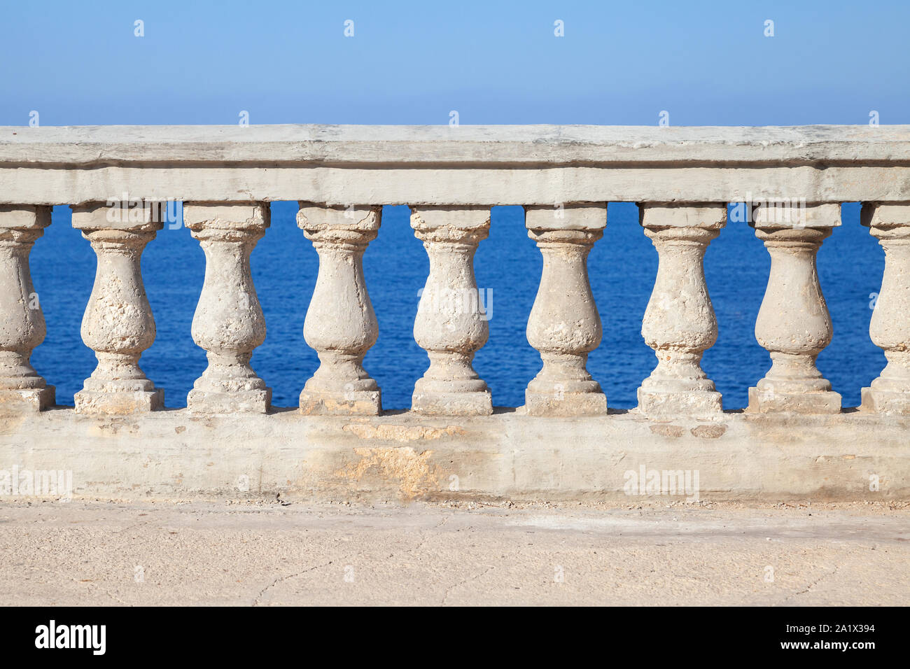 Old stone balustrade with blue sea and sky on a background Stock Photo