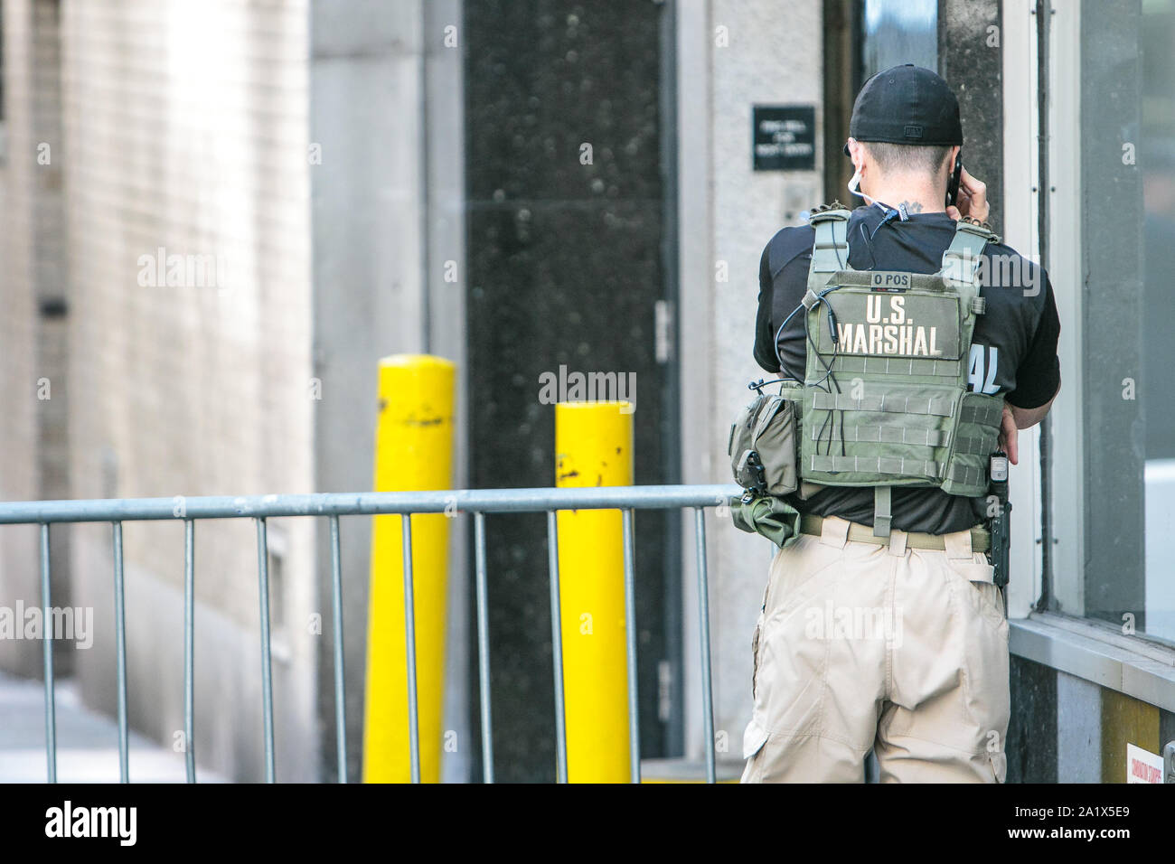 NYC, 9/27/2019: US marshal is talking on the phone while deployed to a police checkpoint near the UN headquarters during General Assembly. Stock Photo
