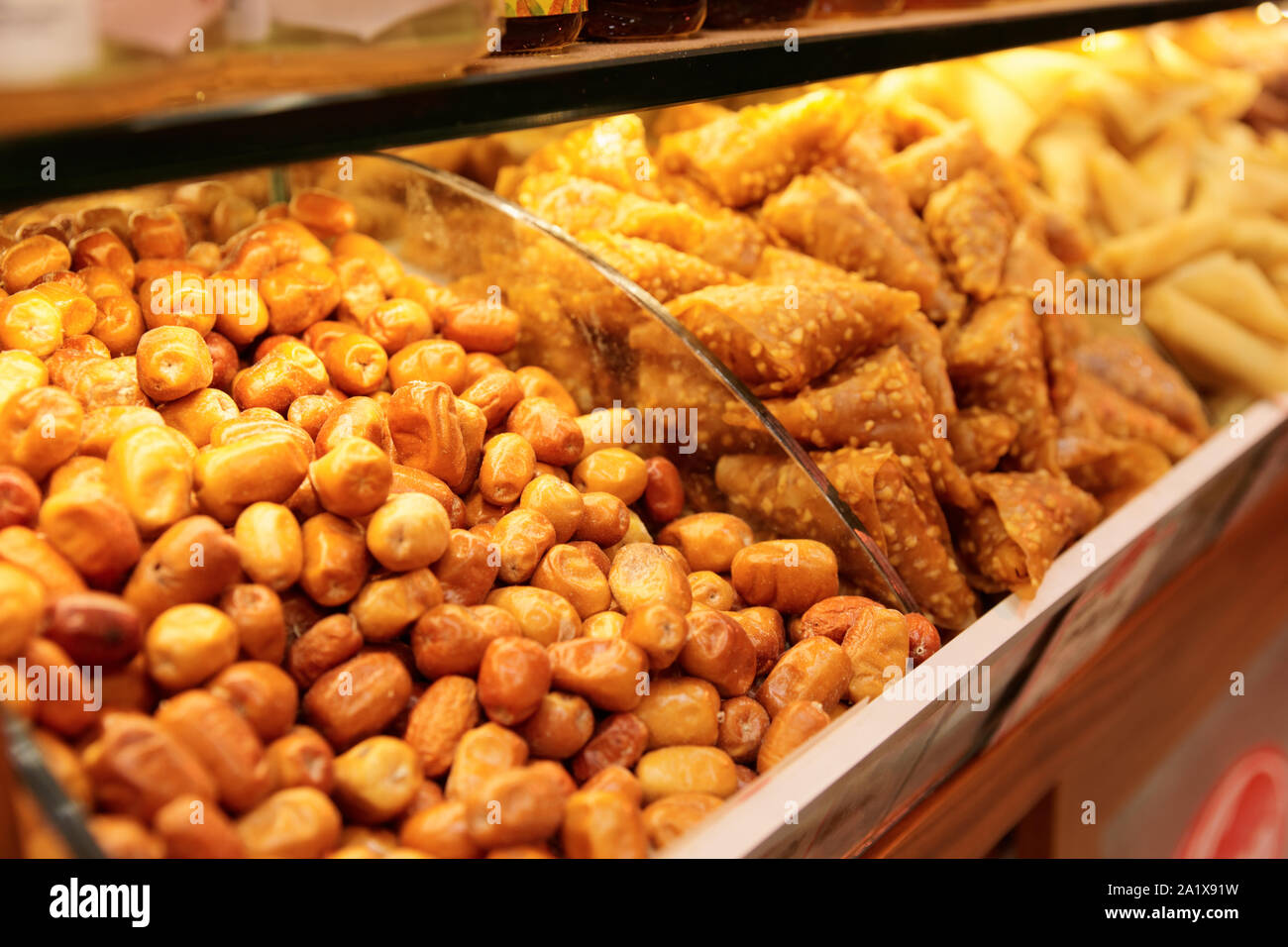 Nuts and baklava on market shelf, close-up Stock Photo