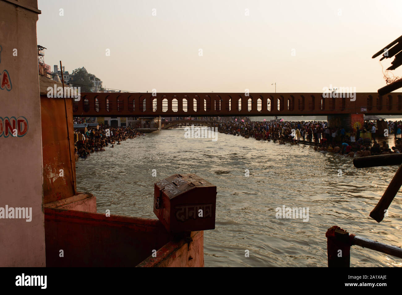 Heavy crowd going to take bath into ganga river due to saavan festival at haridwar bridge temple sky. Stock Photo