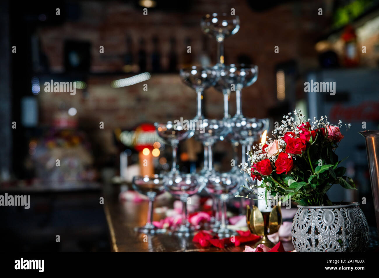 Closeup Table setting, adorned with flowers. Floral decoration for romance dining. Wedding banquet , festive decor. Concept of service and catering. Stock Photo