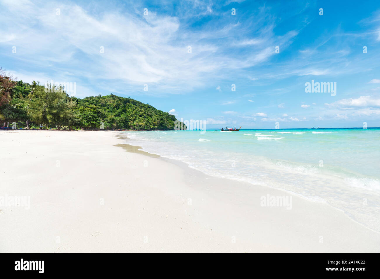 Asian tropical sandy beach paradise with tall palms in Thailand Stock Photo