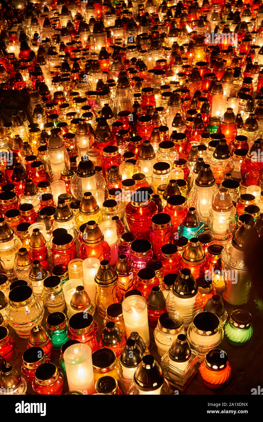 Candles on the grave on the evening of All Saints Day in Poland Stock Photo