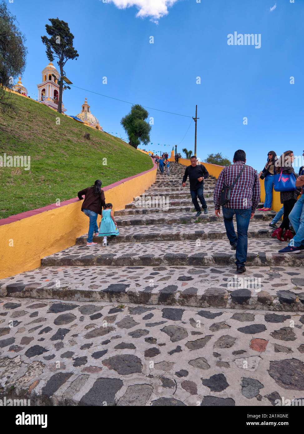 San Pedro Cholula, Mexico, September 30, 2018 - Ascent ladder for the Shrine of Our Lady of Remedies sanctuary with tourist and blue sky at sunny day. Stock Photo