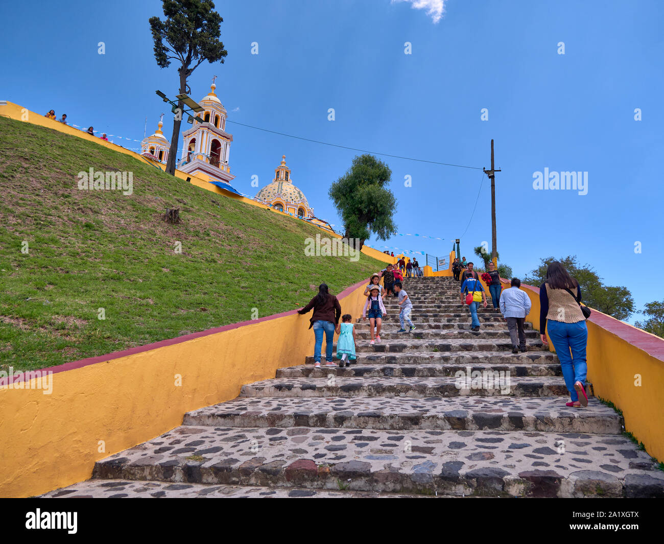 San Pedro Cholula, Mexico, September 30, 2018 - Ascent ladder for the Shrine of Our Lady of Remedies sanctuary with tourist and blue sky. Stock Photo