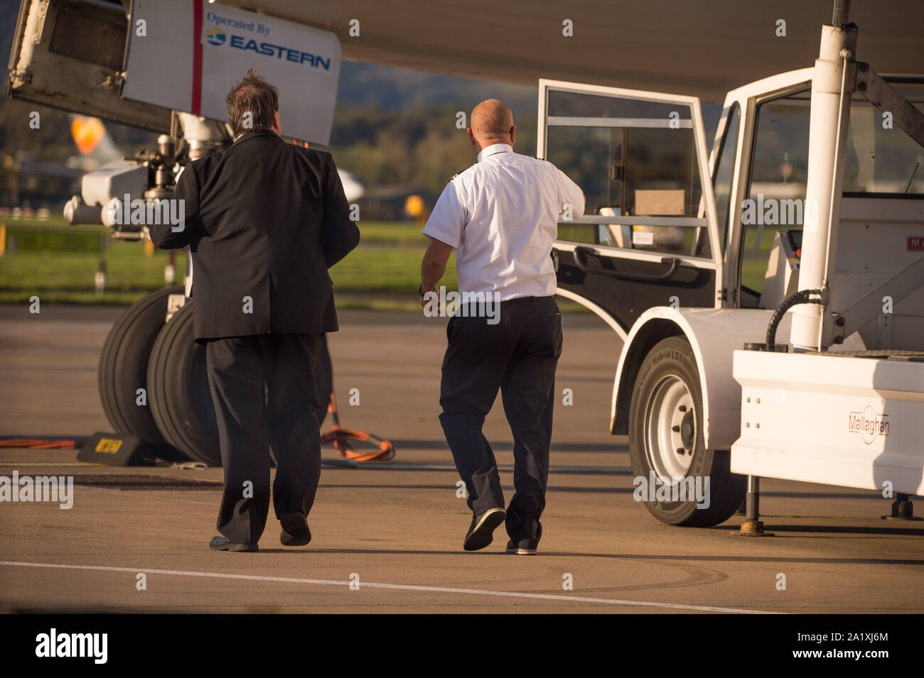 Glasgow, UK. 28 September 2019.  Pictured: Flight crew seen on the tarmac after disembarking their Eastern Boeing 767-300 after just landing. Following the immediate fallout from the collapsed tour company Thomas Cook, Operation Matterhorn is still in full swing at Glasgow Airport. The grounded and impounded Thomas Cook aircraft have been moved to a quieter part of the airfield to make way for the wide body fleet needed for operation Matterhorn. Colin Fisher/CDFIMAGES.COM Stock Photo